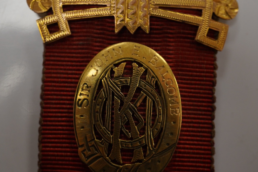 A 9ct gold Masonic 'Royal Order of Antedeluvian Buffaloes' medal, circa 1949, designed as a Maltese cross centring on a buffalo's face with garnet eyes, within a blue enamel garter border, inscribed 'Royal Order of Anted